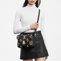 LV_Pochette_Metis_Bicolor_Monogram_Empreinte_Leather_Black_Worn view